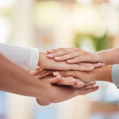Hands, teamwork and support with a business group together in a huddle or circle in solidarity outdoor. Meeting, partnership and motivation with an employee group standing or working in collaboration